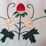 Front of strawberry glove embroidery, finished